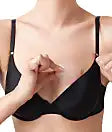 A model wearing a bra demonstrating how to put the Nip It!
